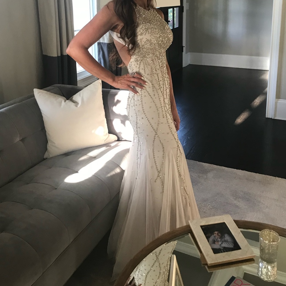 Xscape Nude High Neck Beaded Mesh
Gown with Open Back Long Formal dress.
